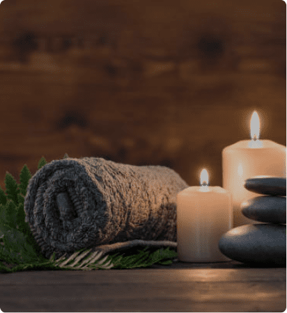 A towel and two candles on top of a table.